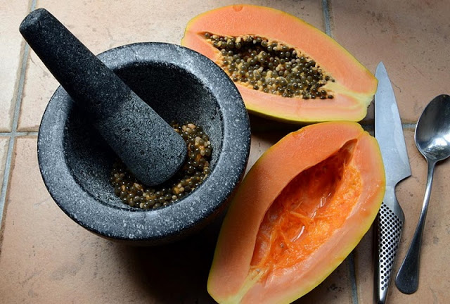 grinding papaya seeds